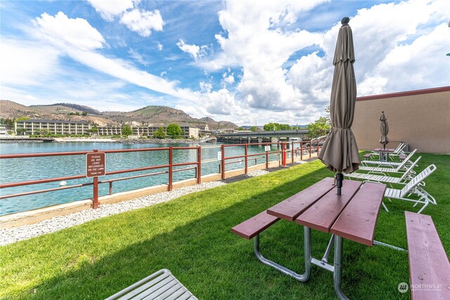 view of yard with a water and mountain view