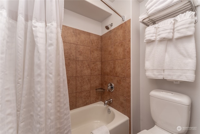 bathroom with shower / tub combo with curtain and toilet