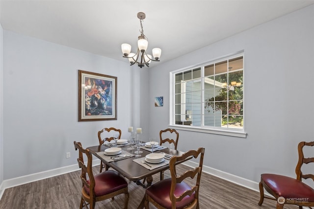 dining room featuring a chandelier and dark hardwood / wood-style floors