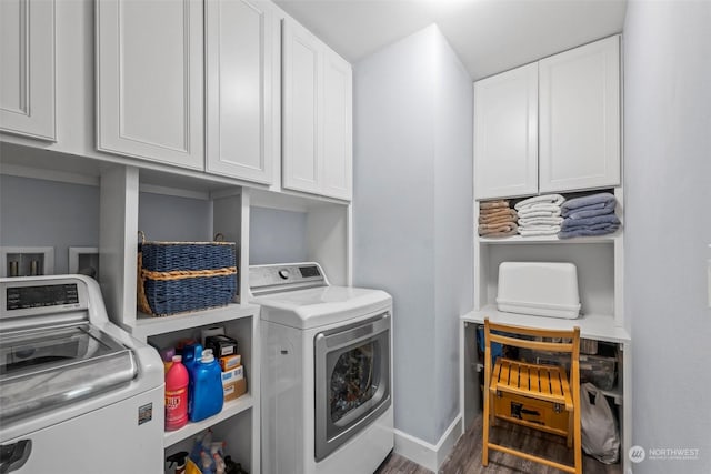 washroom featuring cabinets and washer and dryer