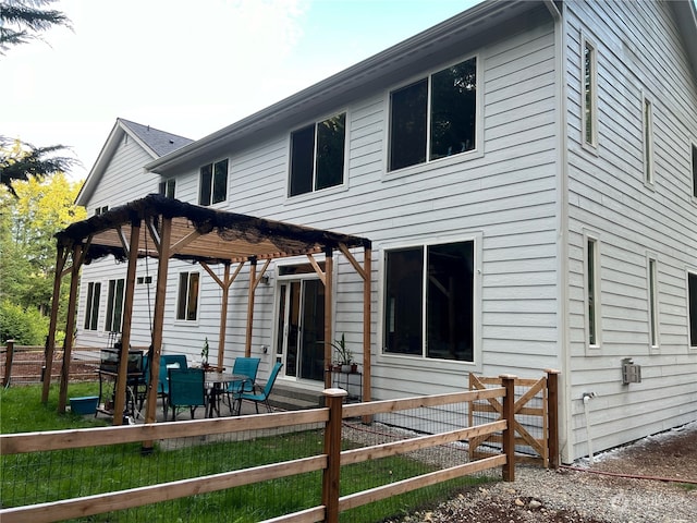 back of house featuring a pergola