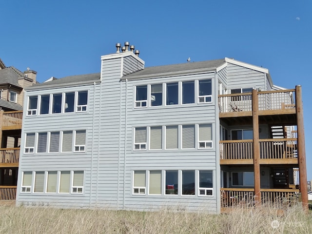 back of property with a balcony