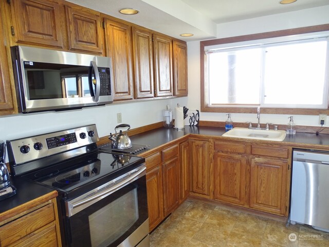 kitchen with stainless steel appliances, light tile floors, and sink