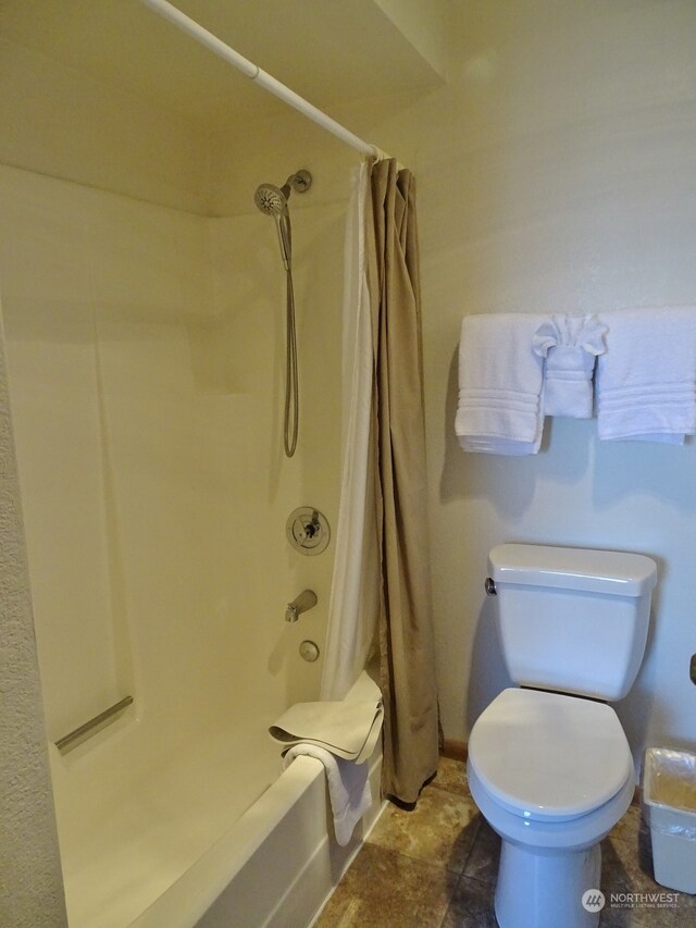 bathroom featuring toilet, tile flooring, and shower / tub combo