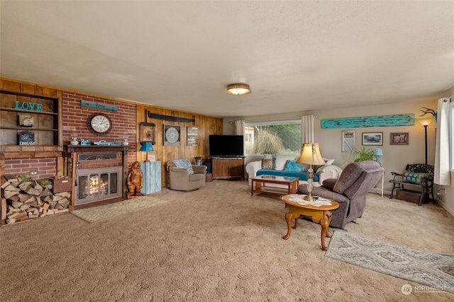 carpeted living room with brick wall, a fireplace, wood walls, and a textured ceiling