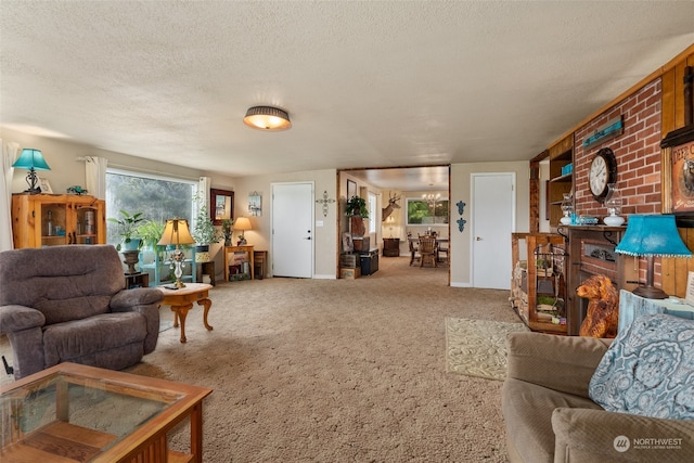 living room with a textured ceiling, brick wall, and light carpet