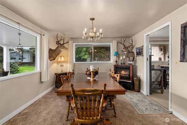 carpeted dining room with a chandelier and a wealth of natural light