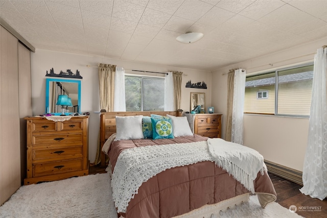 bedroom with dark hardwood / wood-style floors