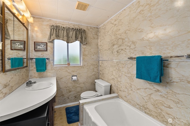 bathroom featuring a tub, tile walls, toilet, and large vanity