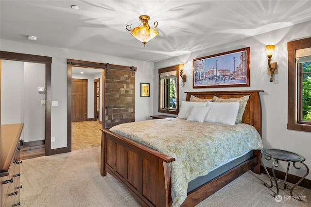 carpeted bedroom with a barn door