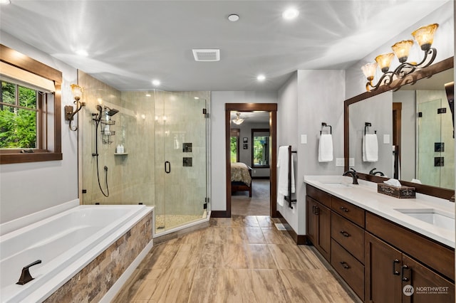 bathroom with separate shower and tub and double vanity