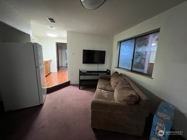 living room with dark carpet