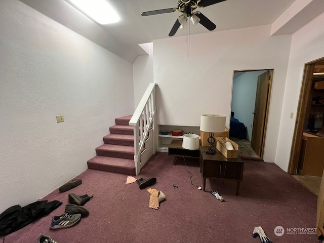 interior space with ceiling fan and dark colored carpet