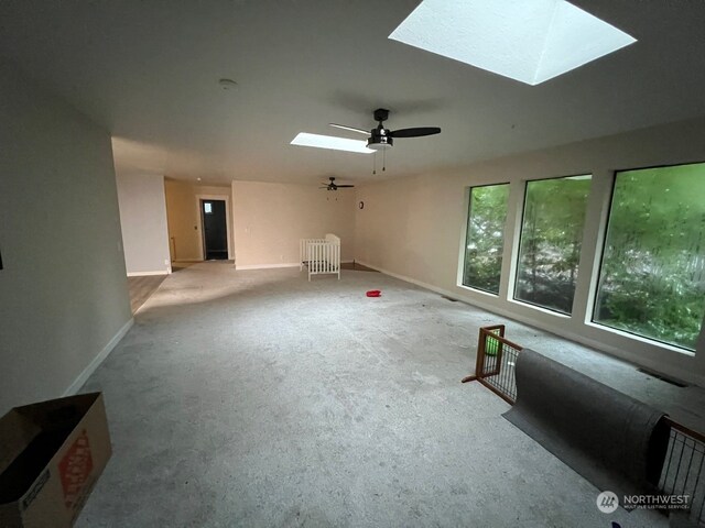 interior space with ceiling fan and a skylight