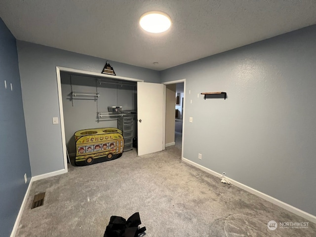 interior space with a closet and a textured ceiling