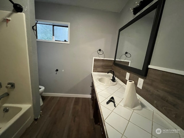 full bathroom featuring vanity, toilet, tub / shower combination, and hardwood / wood-style flooring