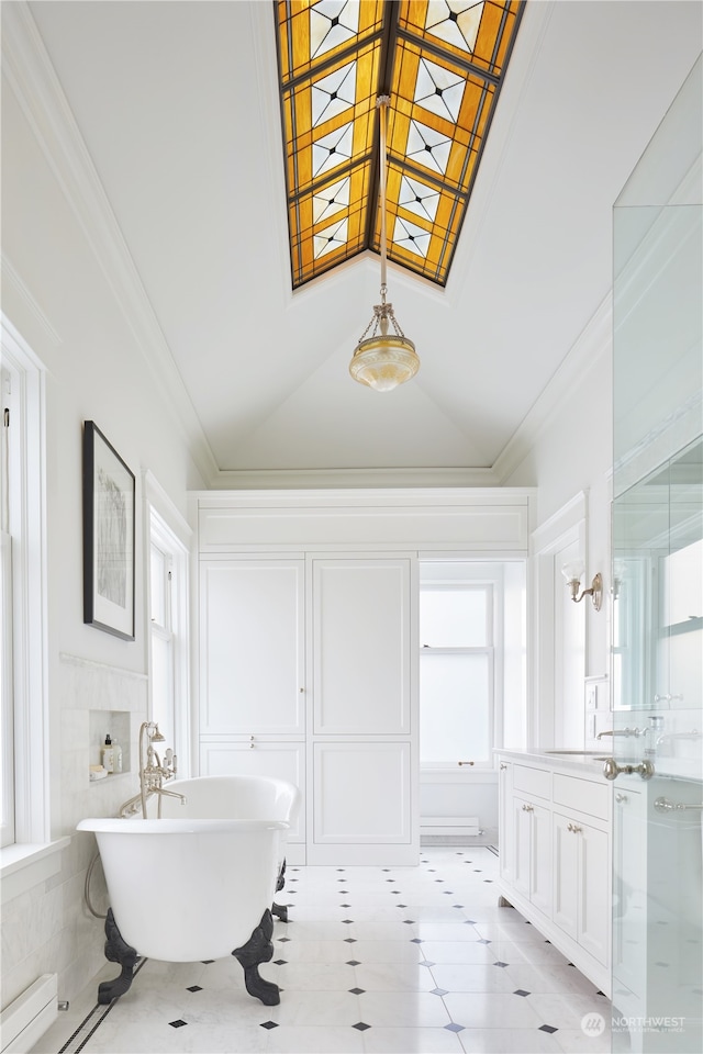 bathroom featuring tile flooring, vanity, a bath, lofted ceiling, and ornamental molding