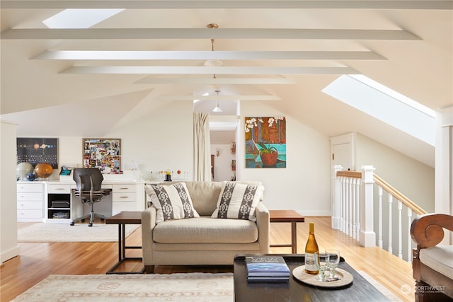 living room with lofted ceiling with skylight and light hardwood / wood-style flooring