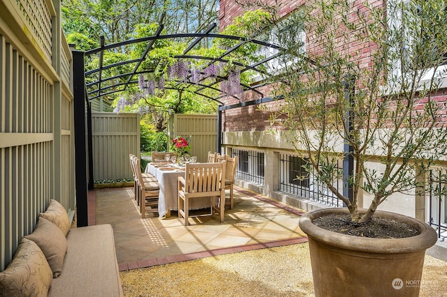 view of terrace with an outdoor hangout area and a pergola