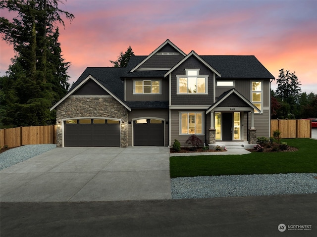 craftsman inspired home featuring a lawn and a garage