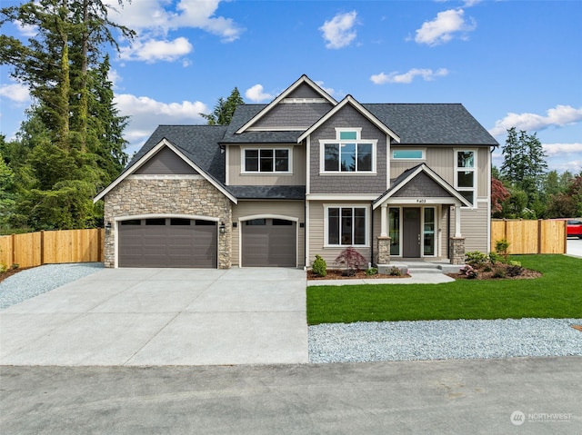 craftsman-style house featuring a front yard and a garage