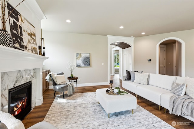 living room with dark hardwood / wood-style flooring and a fireplace