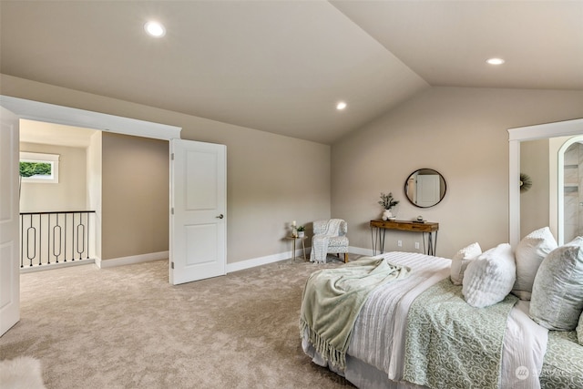 bedroom featuring light colored carpet and lofted ceiling