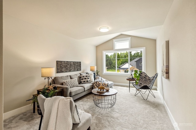 carpeted living room with lofted ceiling