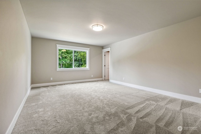 spare room featuring light colored carpet