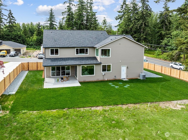 rear view of house featuring a yard, a patio, and central AC unit