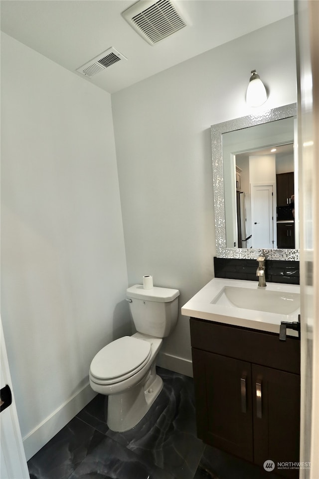 bathroom with toilet and vanity