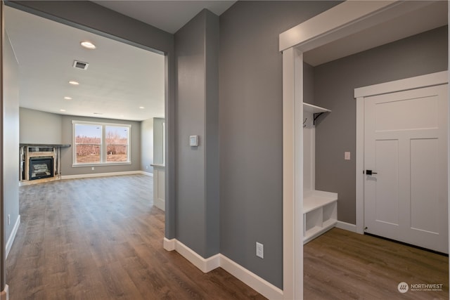 corridor with hardwood / wood-style floors