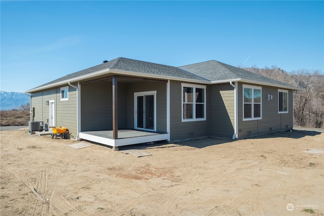 rear view of property with cooling unit