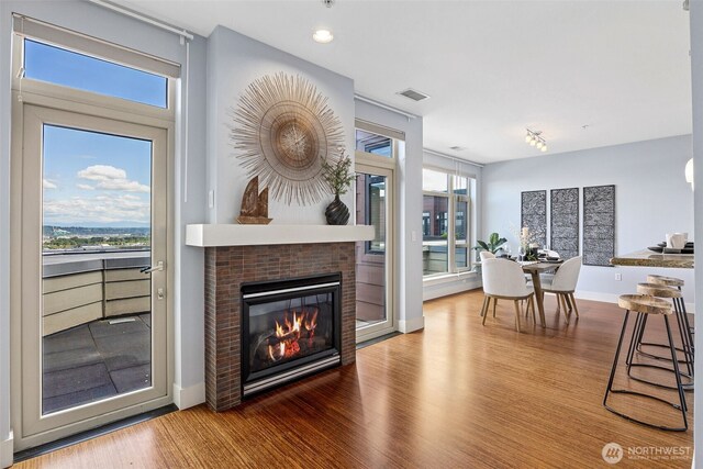 1501 Tacoma Ave S Unit 603, Tacoma, WA 98402 - living area featuring wood finished floors, baseboards, and a glass covered fireplace