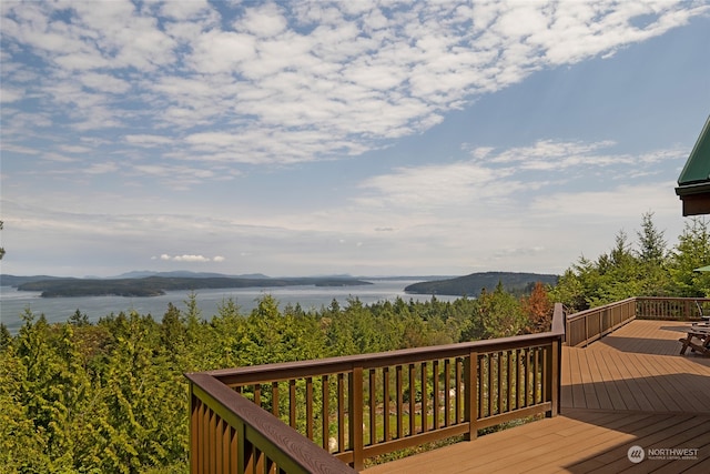 wooden terrace featuring a water view