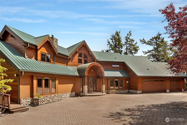 log-style house with a garage