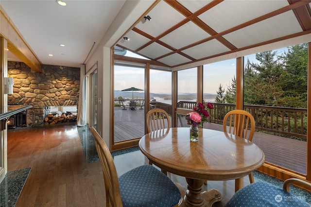 sunroom / solarium with lofted ceiling, a fireplace, and a mountain view