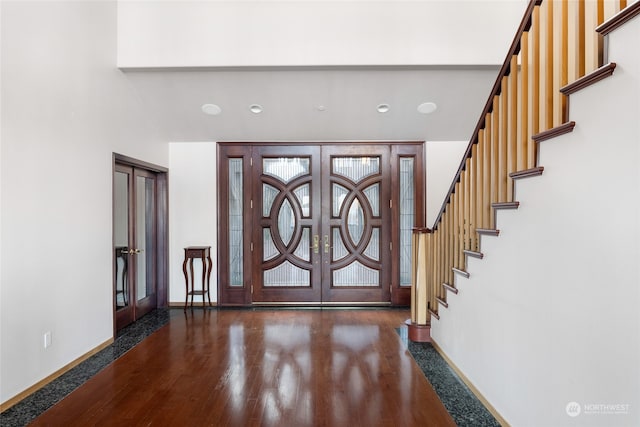 foyer with dark hardwood / wood-style flooring and french doors