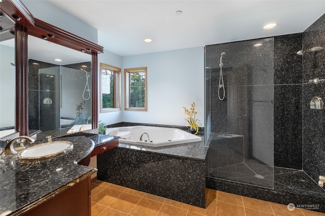 bathroom with tile floors, large vanity, and plus walk in shower