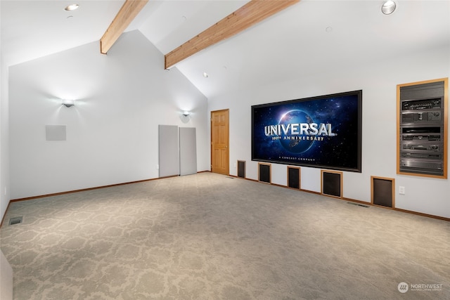 unfurnished living room featuring light colored carpet and vaulted ceiling with beams