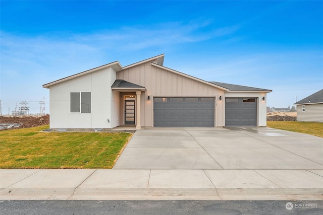 view of front of property featuring a garage and a front yard