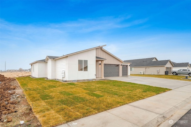 view of front of house with a garage and a front lawn