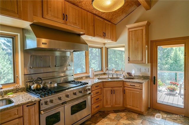 kitchen featuring lofted ceiling with beams, double oven range, wall chimney range hood, light stone countertops, and sink