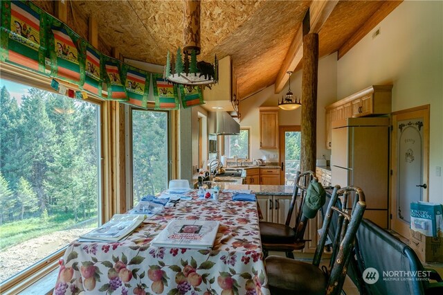 bedroom featuring built in refrigerator and vaulted ceiling with beams