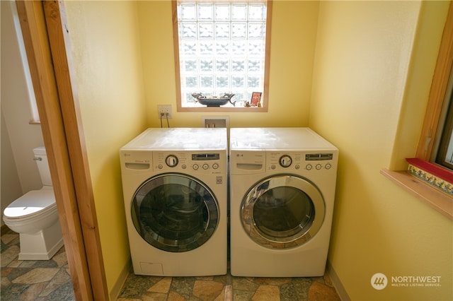 washroom featuring hookup for a washing machine, light tile flooring, and washer and clothes dryer