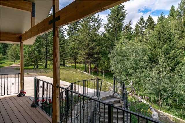 wooden terrace featuring a lawn