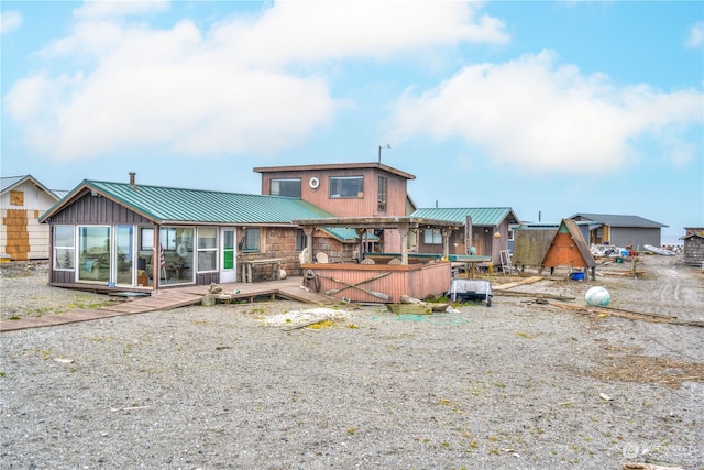 back of property featuring a wooden deck