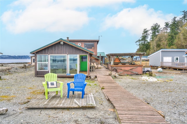 back of house with a deck with water view