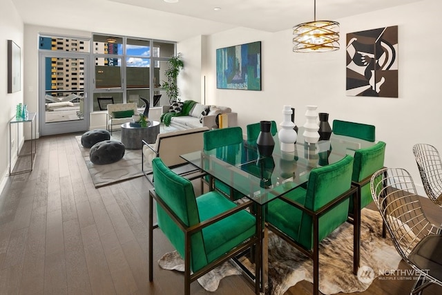 dining space featuring a notable chandelier, floor to ceiling windows, and dark hardwood / wood-style floors