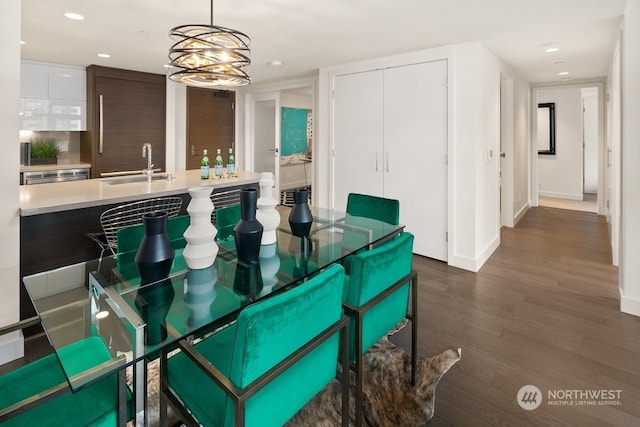 unfurnished dining area with dark wood-type flooring and sink